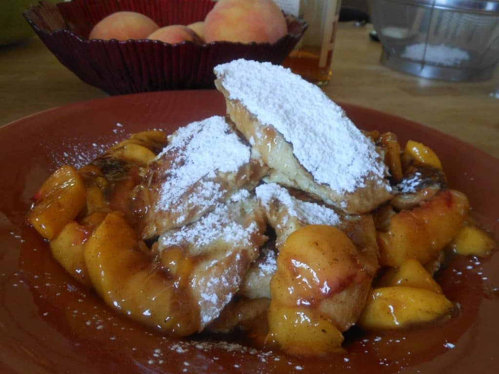 Bourbon Peach French Toast Platter doused in powdered sugar