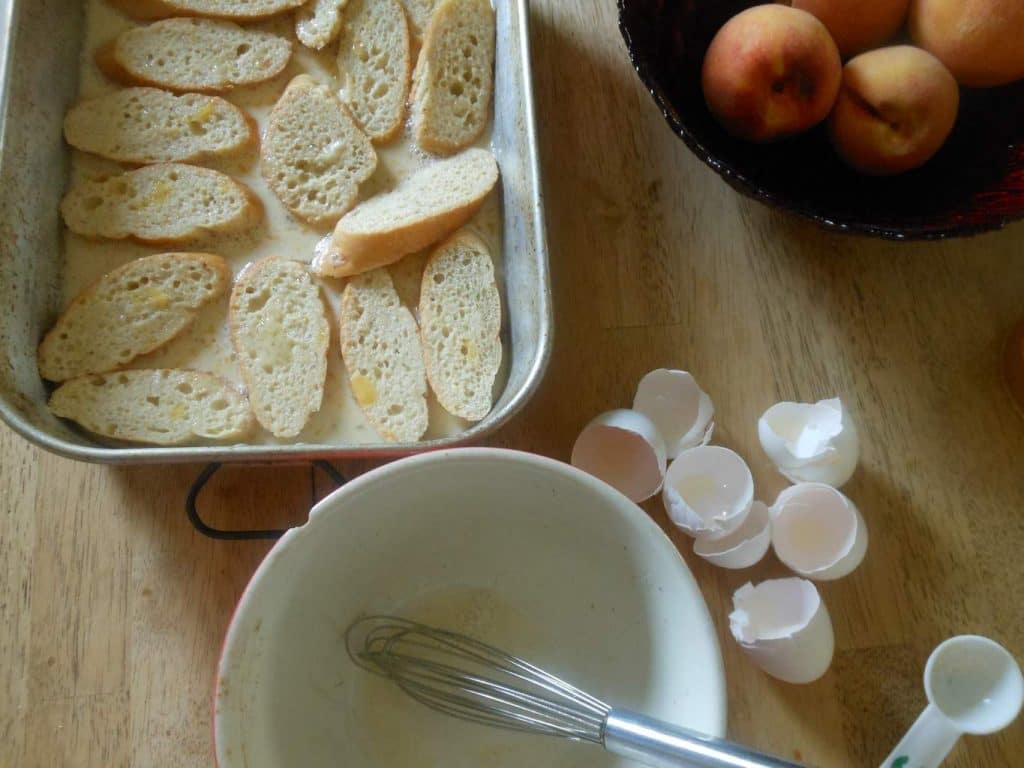 soaking day old bread in eggs, milk, cinnamon, and nutmeg