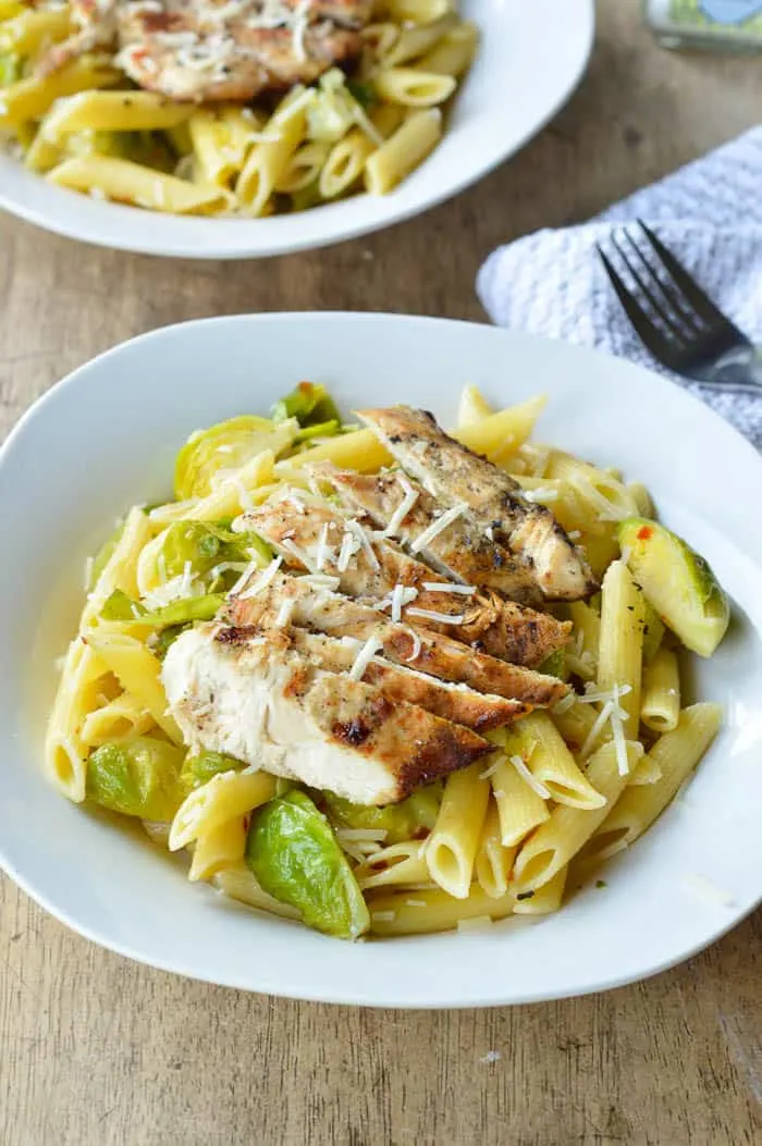 Quick pasta recipe with Grilled Chicken and Brussels sprouts served up in white pasta dishes