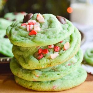 A stack of the Grinch Stole Christmas Cookies with a pretty green color studded with peppermint chips and dark chocolate