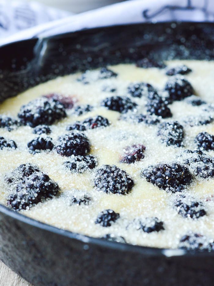 3 tablespoons of coarse turbinado sugar, topping fresh blackberries and buttermilk cake batter in a cast iron skillet