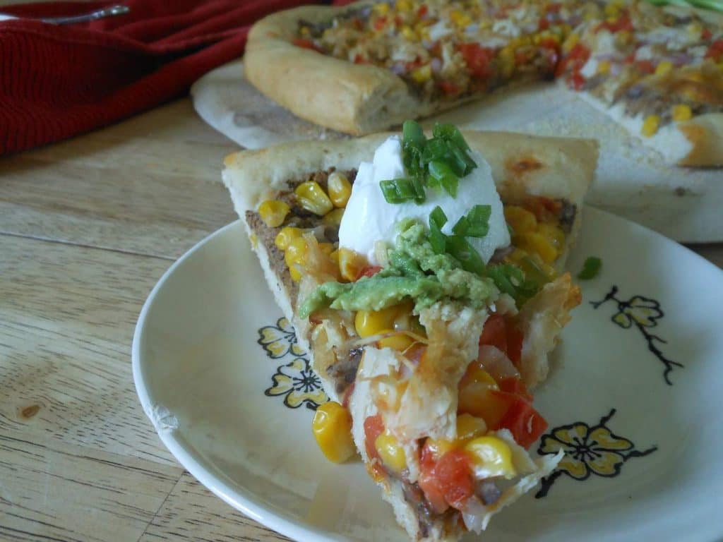 veggie-full pizza with guacamole and sour cream