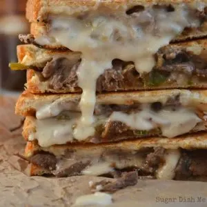 Philly Steak and Grilled Cheese sandwiches stacked and oozing with melted horseradish cheddar