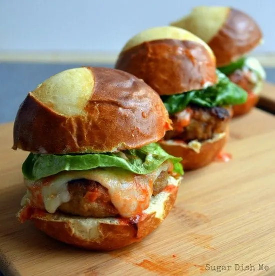 Buffalo Turkey Sliders lined up on a cutting board and ready to impress your appetizer-eating guests!