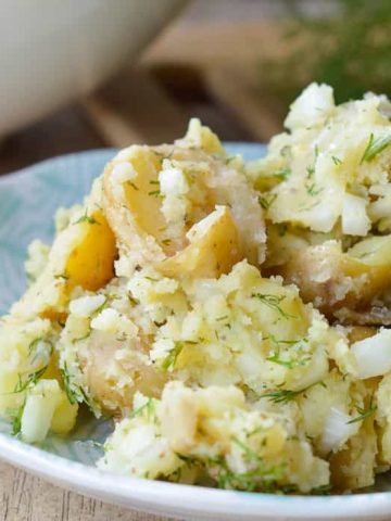 Dill Potato Salad on a pretty plate; close up shot with lots of fresh dill