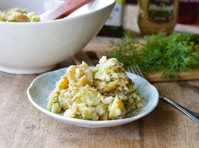 Dill Potato Salad plated with fresh dill in the background