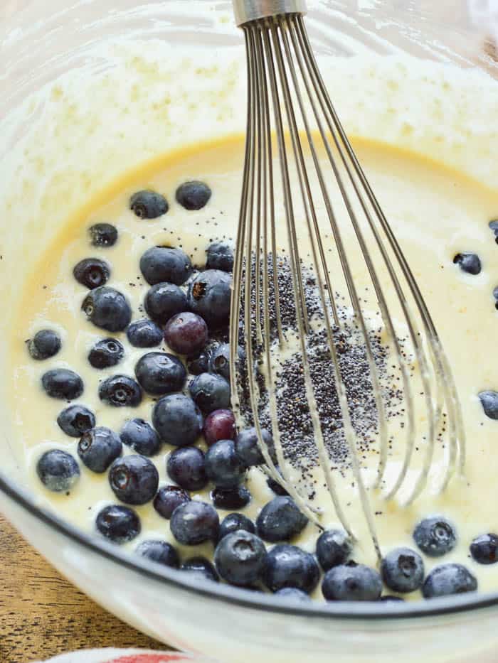 Stirring blueberries into ricotta pancake batter