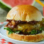 Overhead view of a BBQ bacon burger, bun off and spread with bacon onion jam