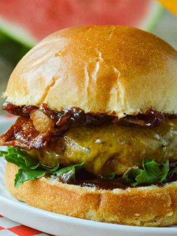 Overhead view of a BBQ bacon burger, bun off and spread with bacon onion jam