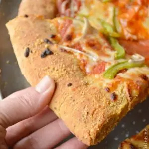 A slice of pizza with Copycat Mellow Mushroom Pizza Dough
