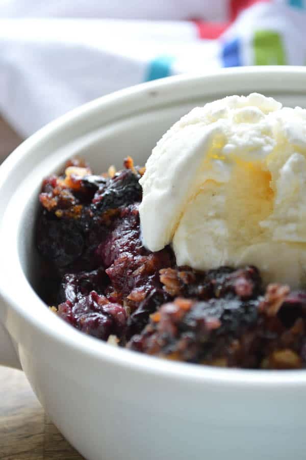 Slow Cooker Blueberry Coconut Cobbler warmed with ice cream on top