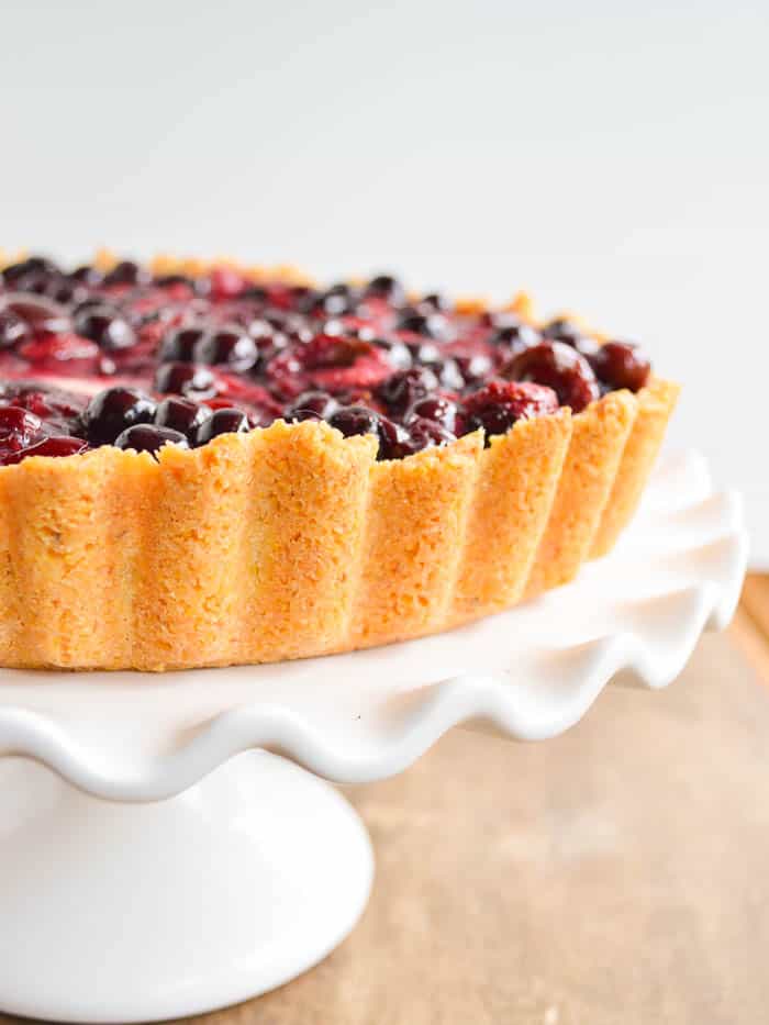 a close up look at the golden polenta crust that this cream cheese pie is baked into