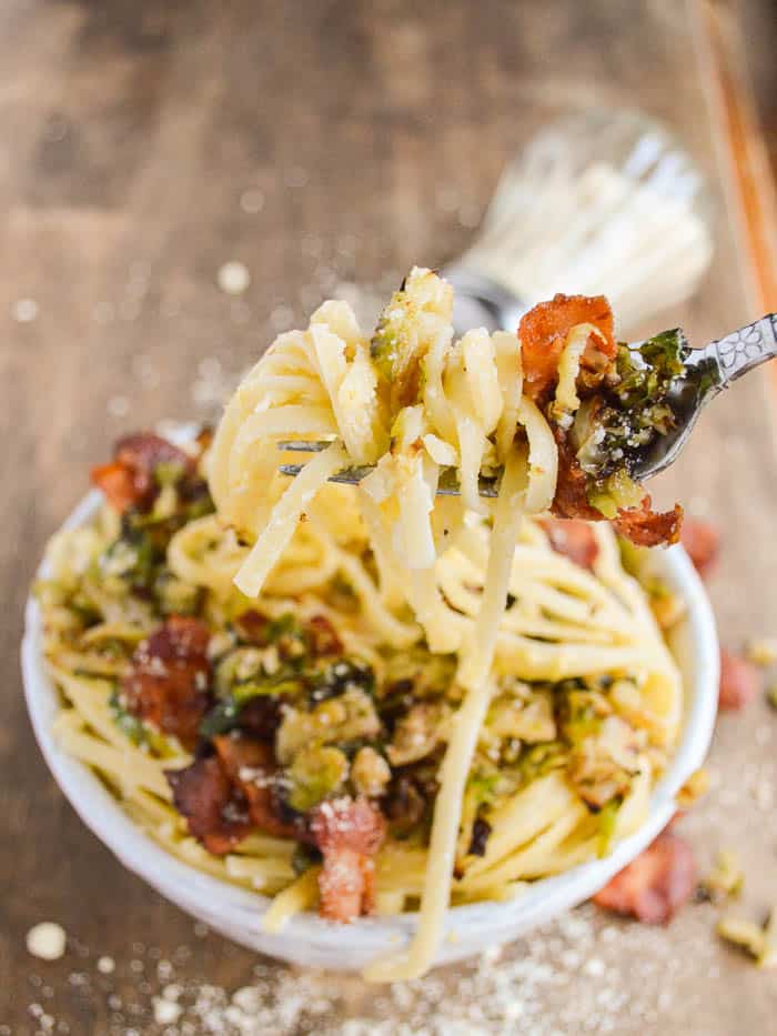 A forkful of Linguine Carbonara with bacon and crispy Brussels sprouts