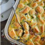 Bacon and Egg Breakfast Bake is made with refrigerated biscuits and lots of cheese. This is an overhead image of the casserole ready to serve. Photo with text.