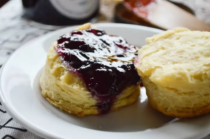 Biggest Fattest Fluffiest All Butter Biscuit split and heaped with blueberry lemon jam makes for an amazing breakfast.