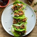 Chinese Pork lettuce Wraps overhead image; bright green Boston Bibb lettuce, tender Chinese BBQ pork, and a little sticky jasmine rice.