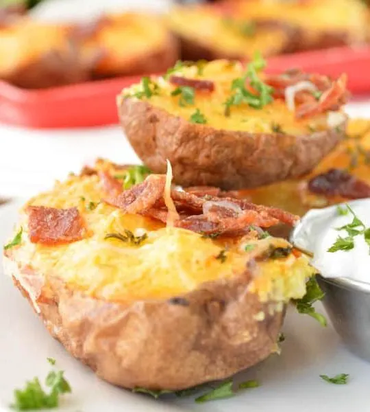 Twice Baked Breakfast Potatoes topped with bacon and parsley