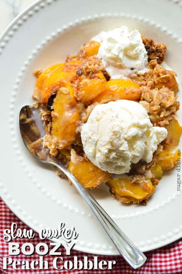 Slow Cooker Boozy Peach Cobbler is loaded with warm peaches, spiced rum, and a crumbly oat topping