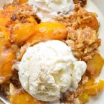 Permalink to: Slow Cooker Boozy Peach Cobbler Warm fresh peaches are slow cooked with a tasty oatmeal topping and spiced rum, and then topped with vanilla ice cream!