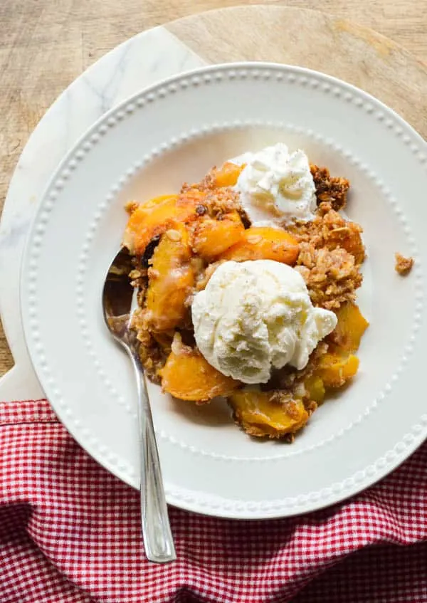 Slow cooked peaches with spiced rum and ice cream