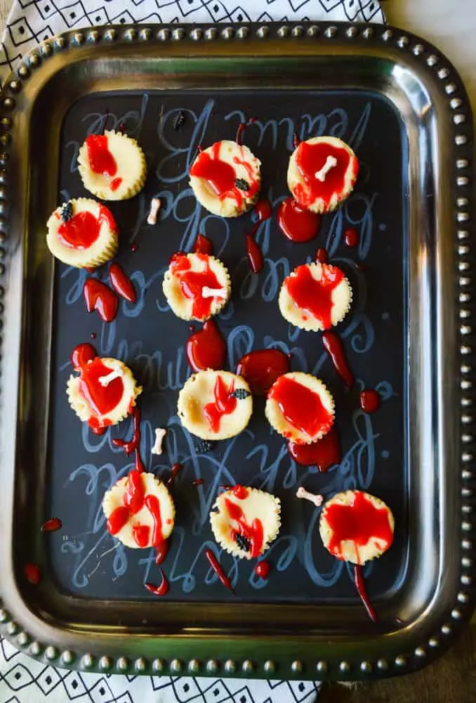 Bloody Good Mini Cheesecakes are the best little boozy Halloween cheesecake treat! So spooky with the red gel frosting on top. 