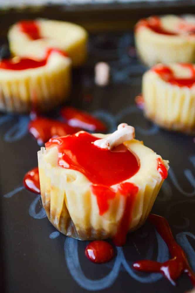 Bloody Good Mini Cheesecakes have a gingersnap crust and spiced rum! Covered in a spooky red gel frosting and perfect for Halloween!