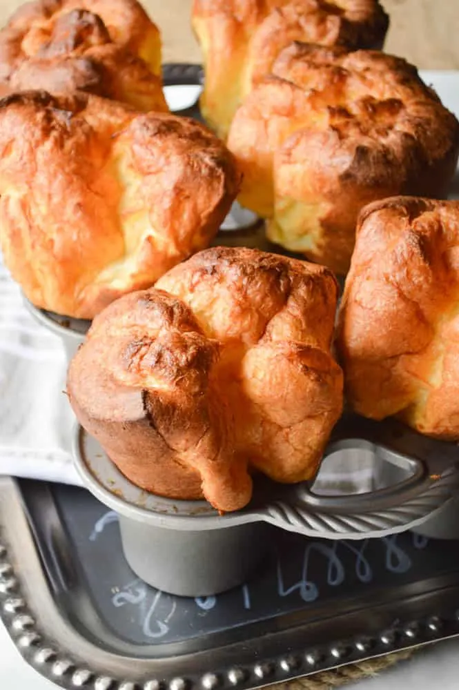 Fluffy golden popovers still in the pan. So tall you won't believe it! 