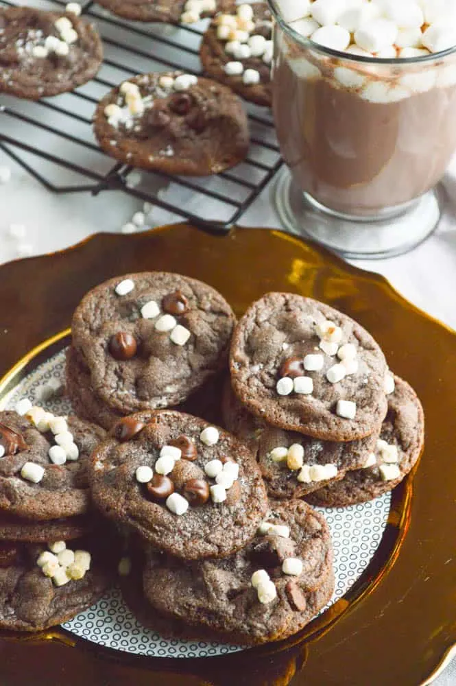 Hot Cocoa Cookies plated with a cup of hot cocoa