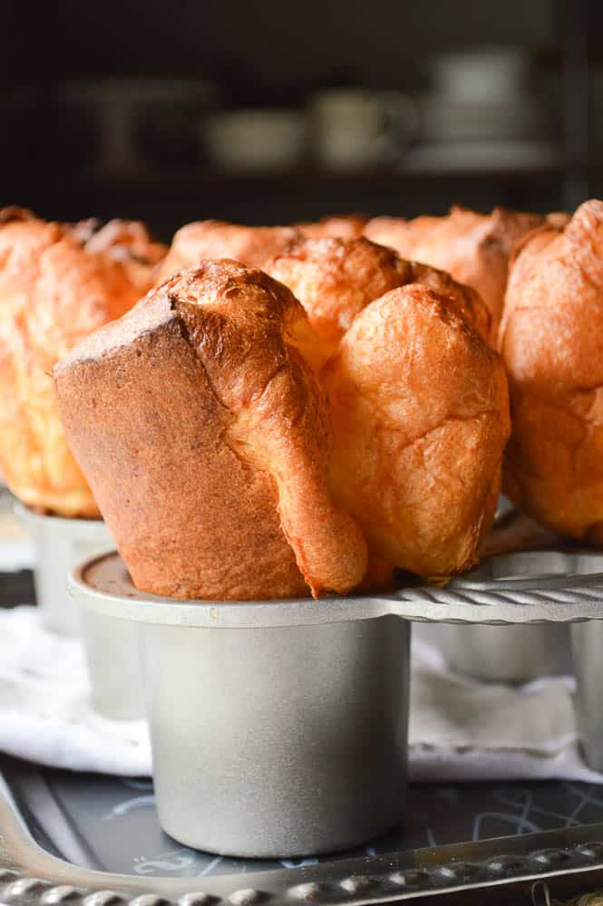 The Biggest Fattest Fluffiest Popovers vertical shot still in the pan so you can see just how tall they are