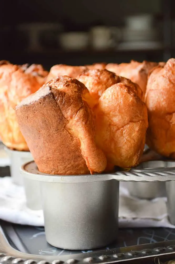 The Biggest Fattest Fluffiest Popovers vertical shot still in the pan so you can see just how tall they are