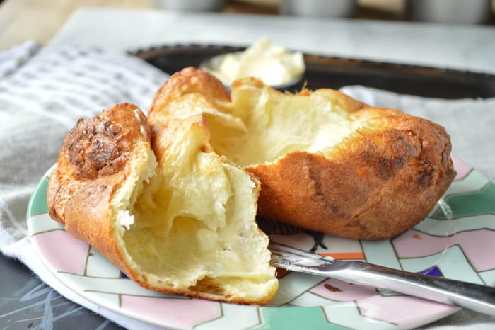 Turn Big Fat Fluffy Popover with lots of melted butter 