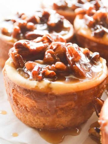 Square close up image of little spiced rum pecan cheesecakes