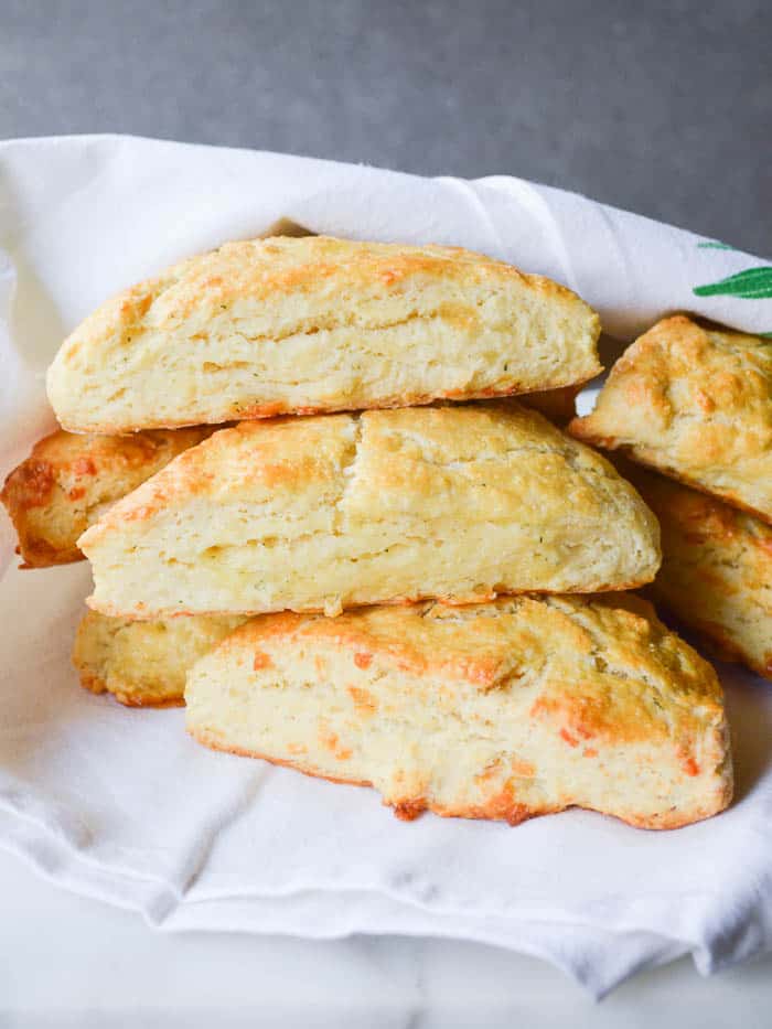 Garlic Herb and Cheddar Scones stacked with a cheesecloth