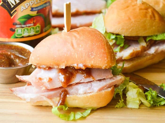 Small sandwiches piled high with apple butter glazed ham and speared with a toothpick for easy handling