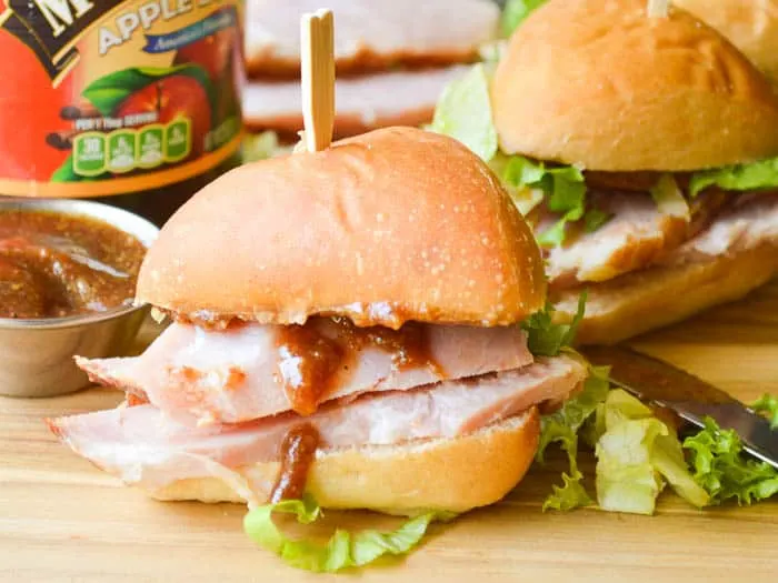 Small sandwiches piled high with apple butter glazed ham and speared with a toothpick for easy handling