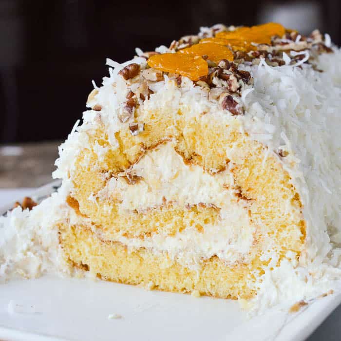 This cake roll recipe is filled with pineapple fluff and covered in coconut