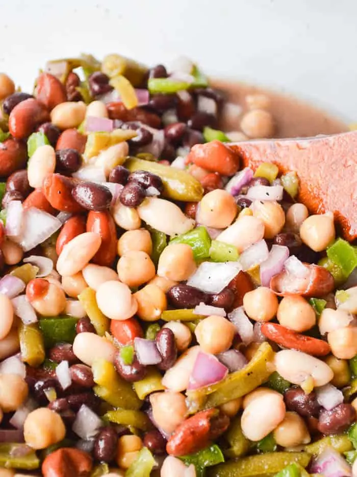 Stirring the ingredients together to make the Best Easy 5 Bean Salad. 