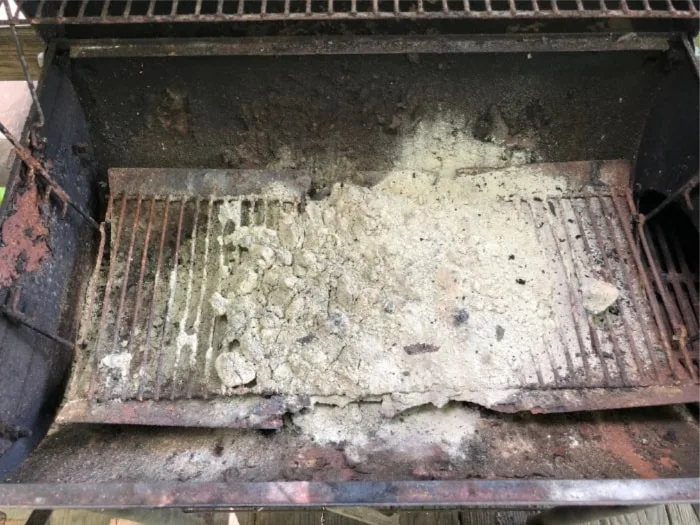 rusted out ash pan from a Char-Griller charcoal grill