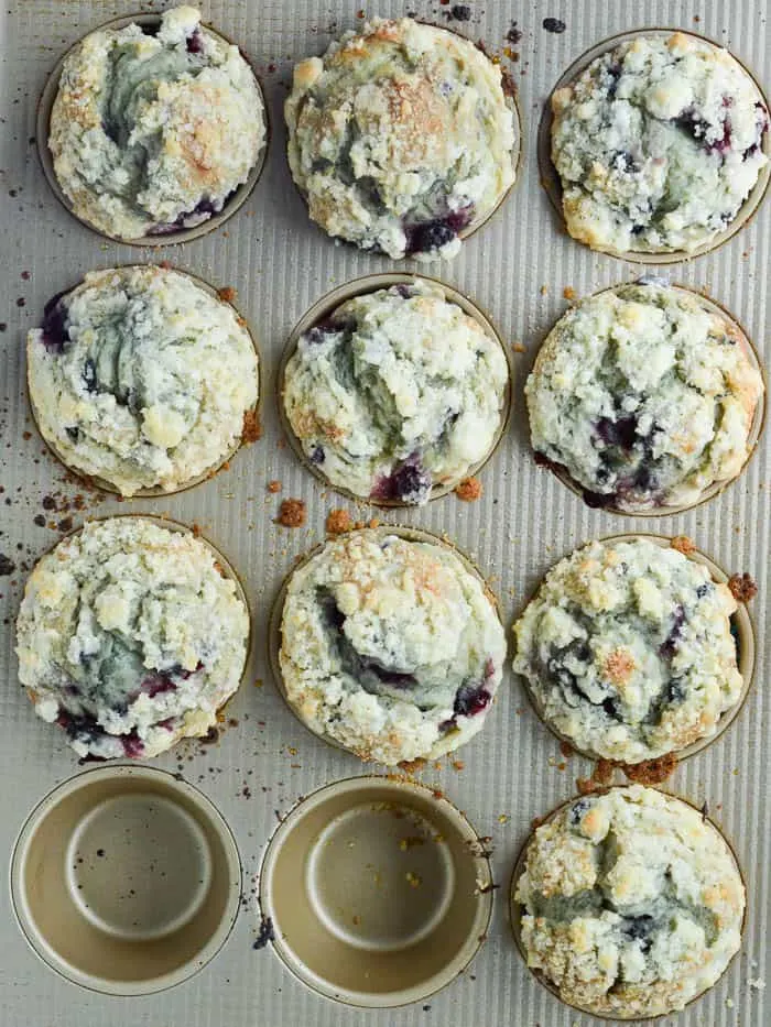 streusel-topped blueberry muffins still in the pan