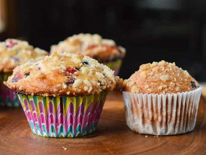 a side by side comparison of muffins. One is made with a box mix but with bakery-style tips, and the other is made following the box mix instructions