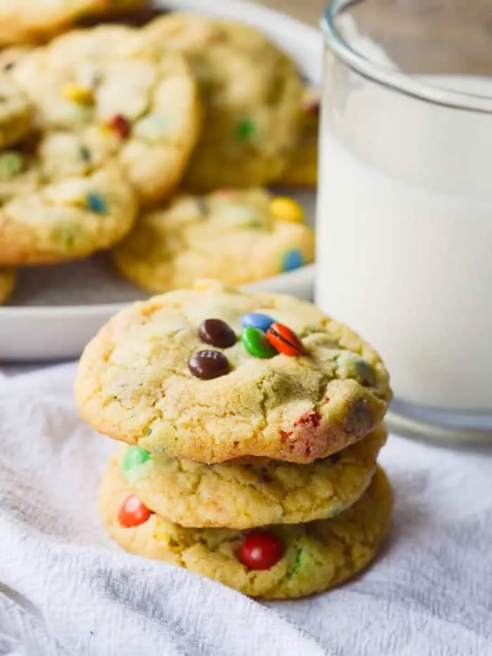 a stack of soft and chewy pudding cookies studded with M & M's