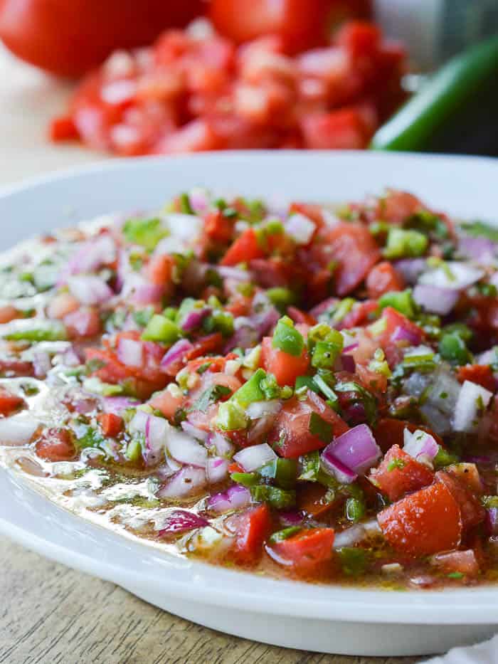 Easy Pico de Gallo ready to serve! Loads of fresh chopped Roma tomatoes, red onion, jalapeno, garlic, and cilantro