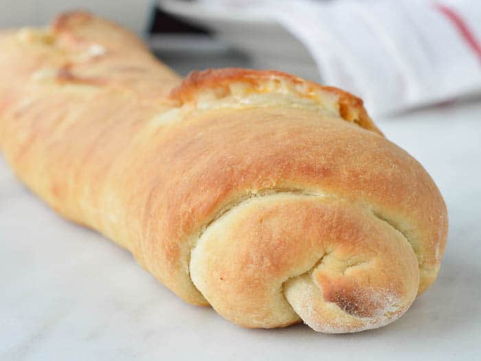 This easy stromboli recipe is mae with soft homemade rolled pizza dough and loaded with cheese. Warm from the oven and ready for slicing. 