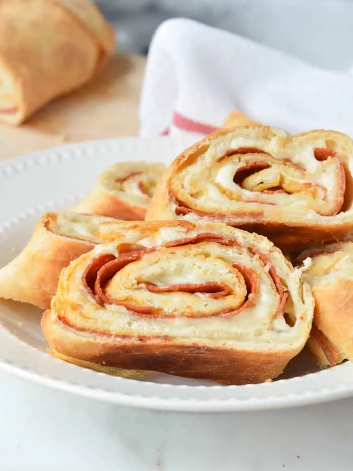 Easy Stromboli Recipe made from scratch, sliced in a white dish and ready to serve! 