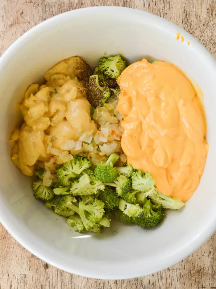 The ingredients needed for a classic broccoli rice casserole - fresh broccoli, sauteed onions, Cheez Whiz, pepper, and cream of mushroom soup