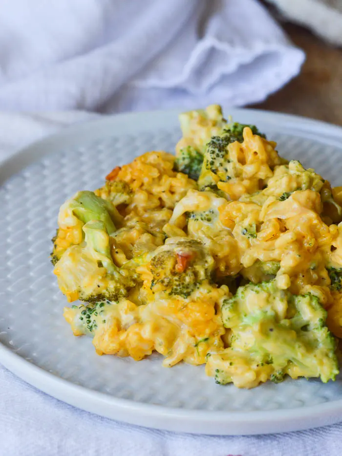 Classic Broccoli Rice Casserole plated and ready to serve. This dish is super cheesy and studded with bright green broccoli florets - the perfect side dish for any occasion!