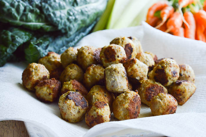 A plate lined with a paper towel filled with little bite-sized meatballs