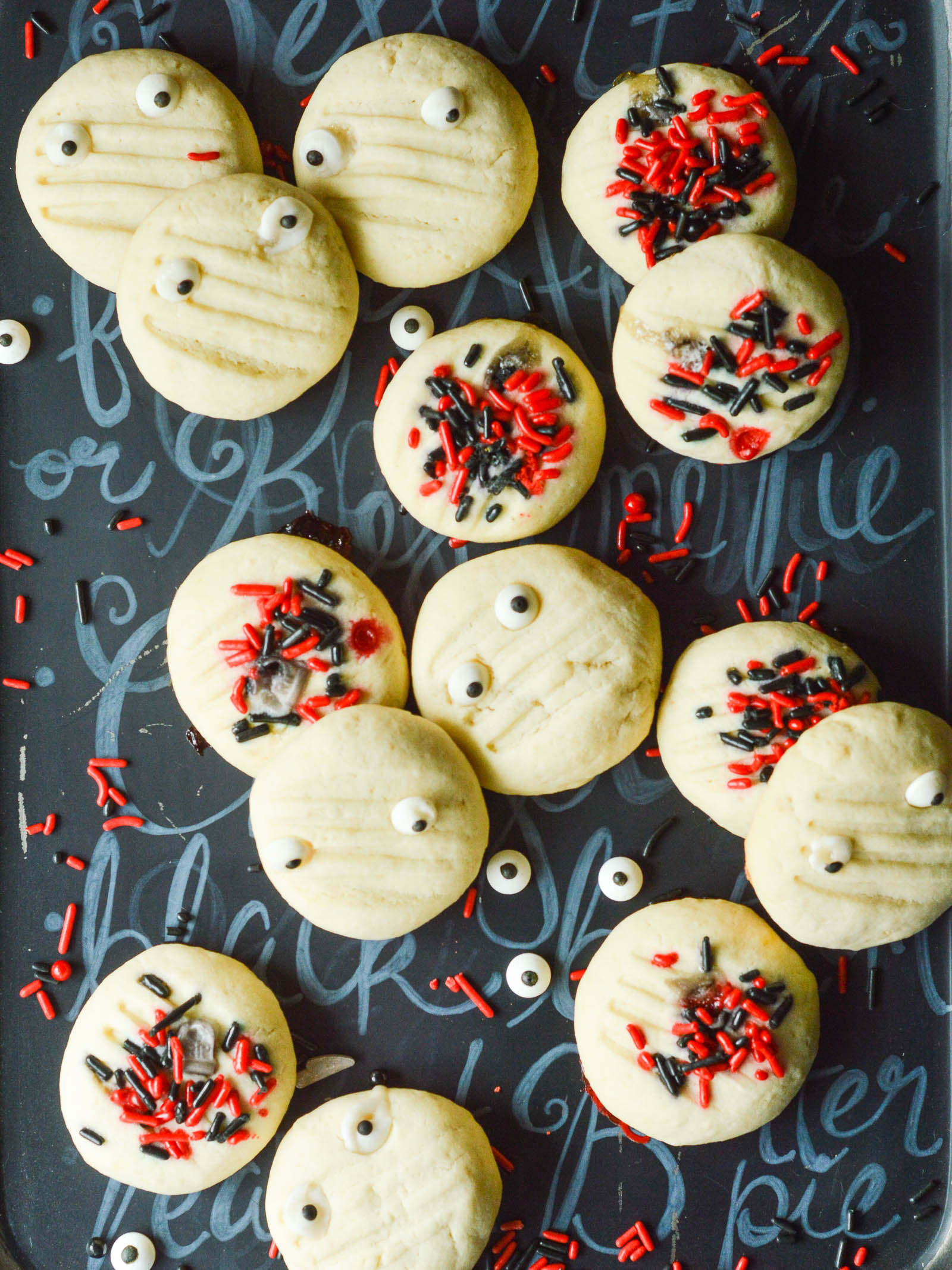 A tray of Halloween Shortbread Cookies, all dotted with Halloween sprinkles and candy eyes