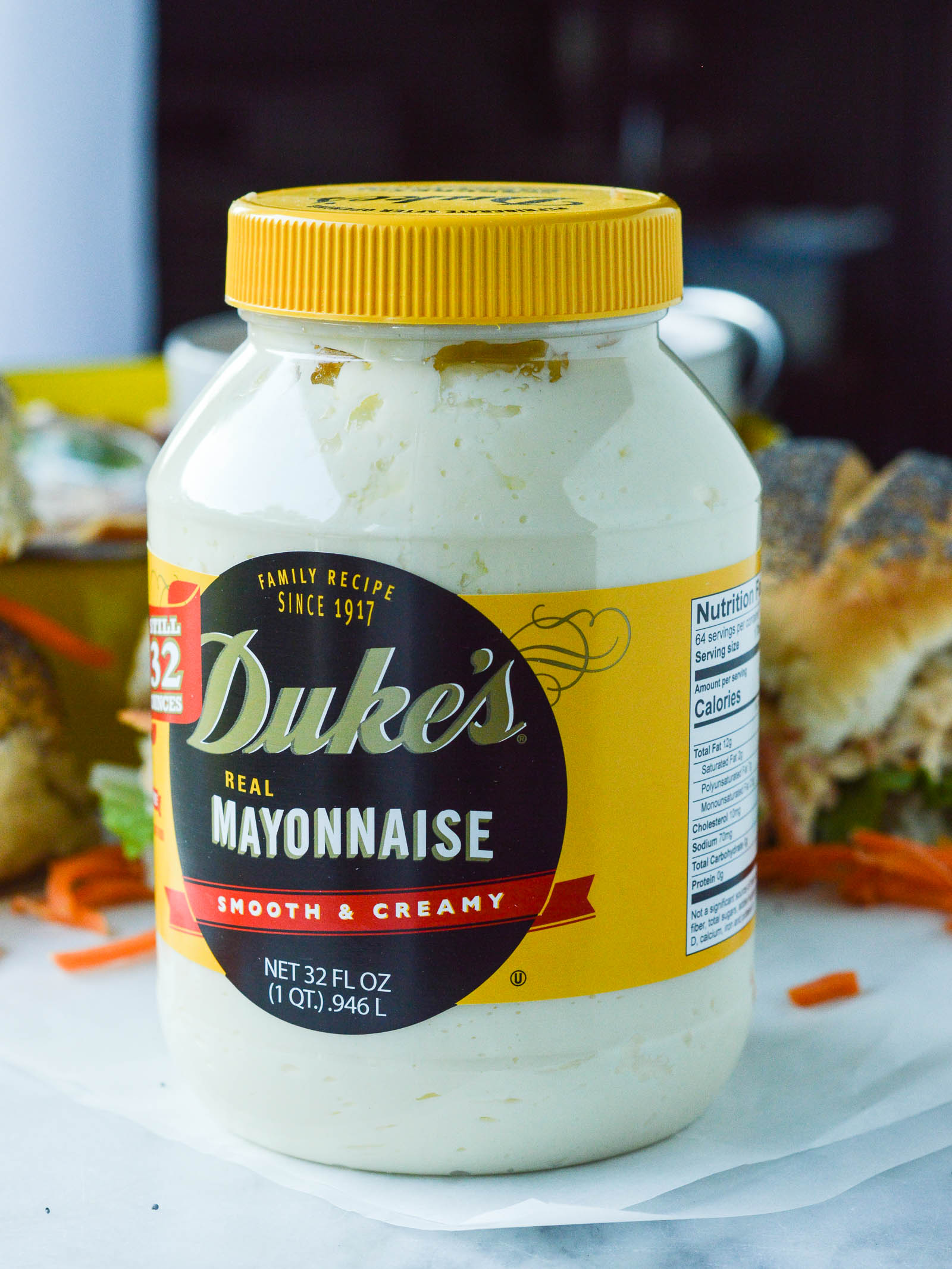 A jar of Duke's mayonnaise with Buffalo Chicken salad sandwiches in the background