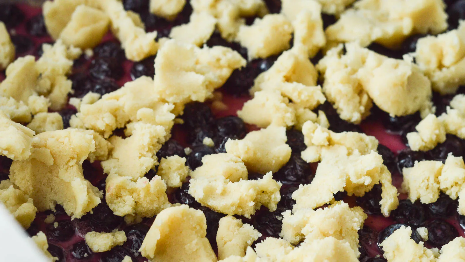Crumbled shortbread topping dotted over the champagne blueberry filling for these easy blueberry crumble bars